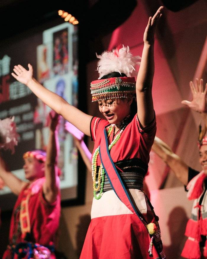 Event photographer capturing a performer in traditional costume at a Penang cultural dance performance