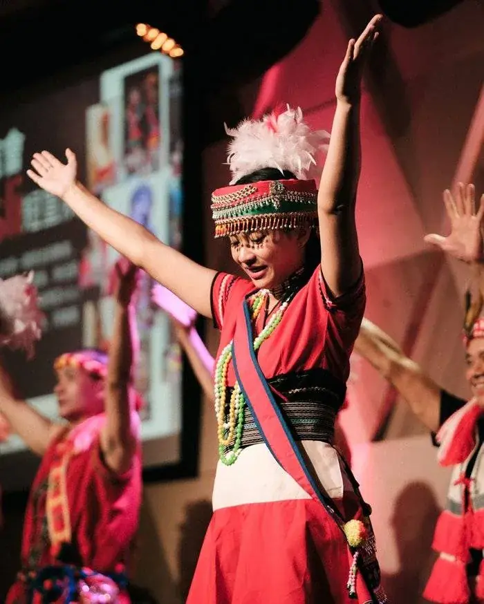 Event photographer capturing a performer in traditional costume at a Penang cultural dance performance