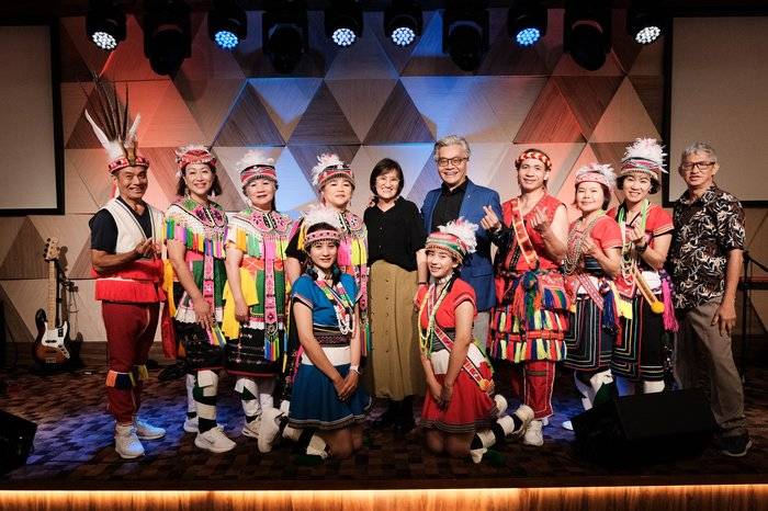 Event photographer capturing performers in traditional costume on stage