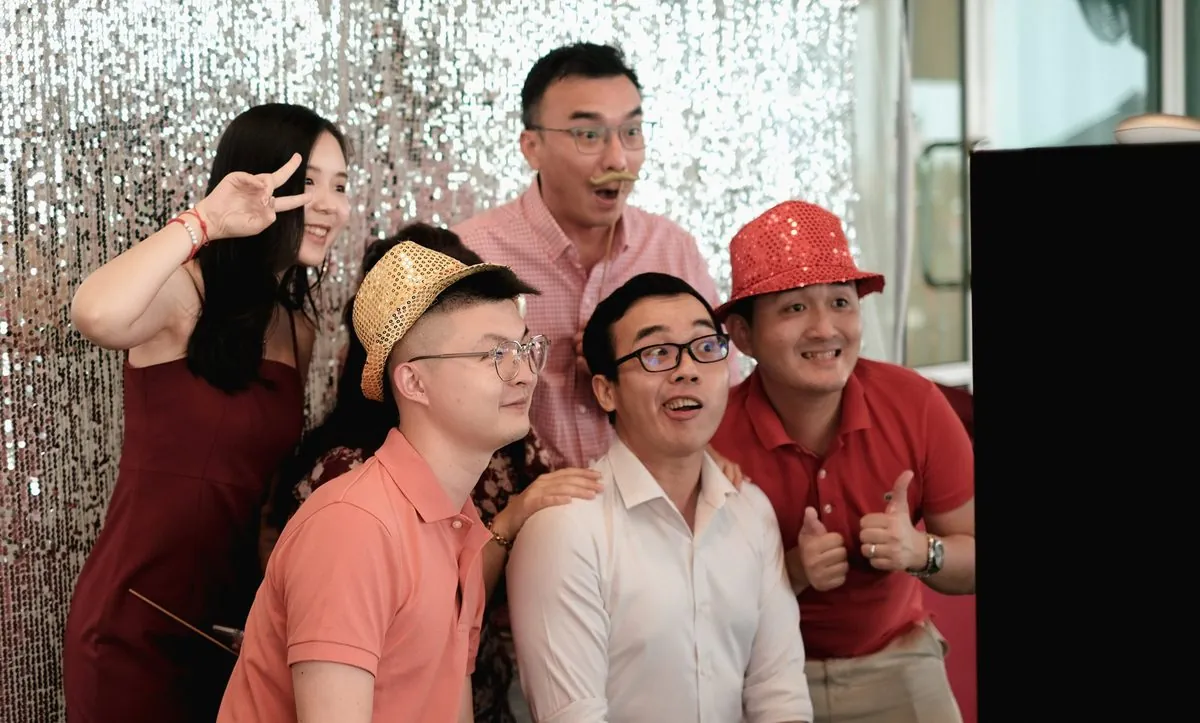 Guests in sequin hats pulling faces at a Four Fat Bros photobooth in Penang