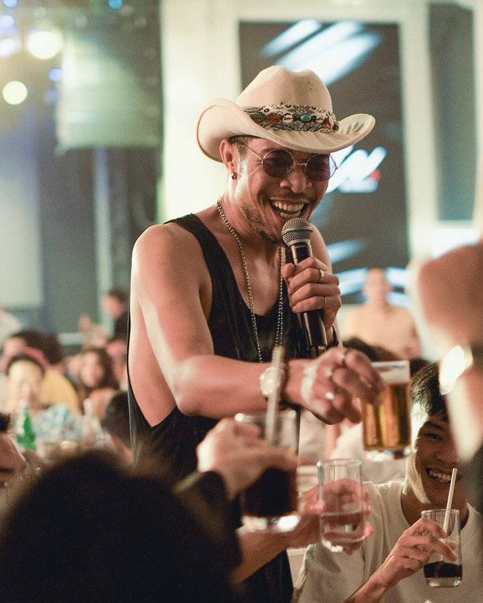 Penang event photographer capturing a singer performing with a live band at an event