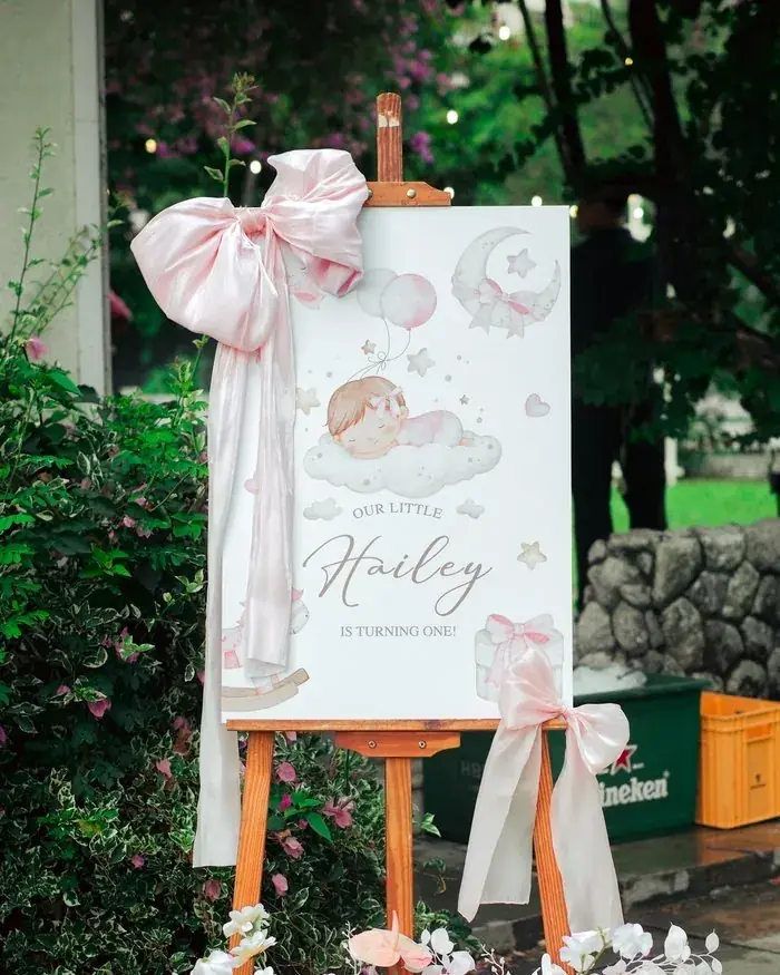 Penang event photographer capturing a pink birthday welcome sign for a baby's first birthday celebration